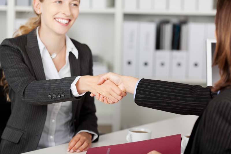 Insurance agent and a female client shaking hands